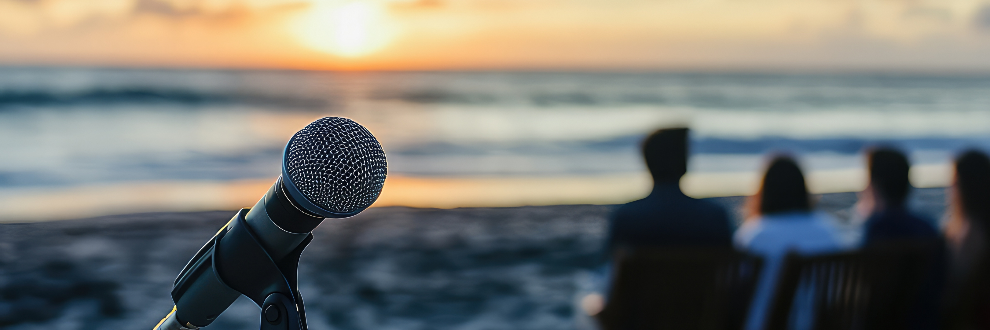 Microphone in focus with team seated by the ocean at sunset — Coastal Finance Meet the Team banner